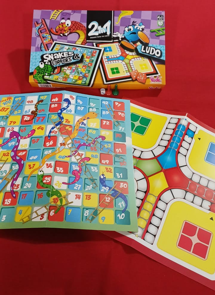Snakes and Ladders game with colorful board and cards on a red background
